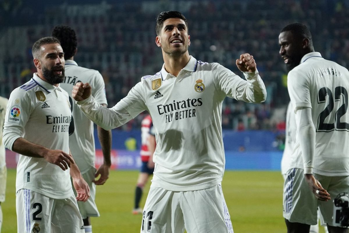 Marco Asensio merayakan golnya dalam pertandingan Osasuna vs Real Madrid pada pekan ke-22 Liga Spanyol 2022-2023 di Stadion El Sadar, Minggu (19/2/2023) dini hari WIB. Laga Osasuna vs Real Madrid tuntas dengan skor 0-2. Artikel ini memuat klasemen Liga Spanyol 2022-2023. (Foto oleh CESAR MANSO / AFP)