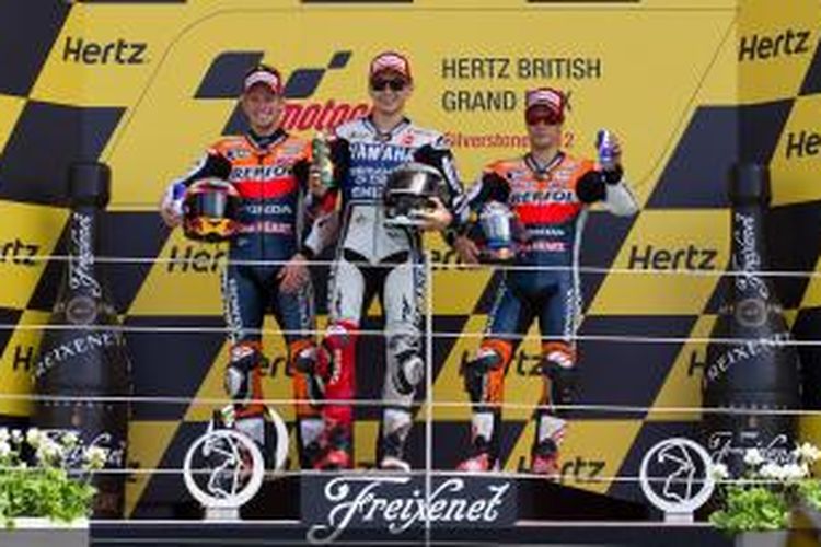 Pebalap Spanyol, Jorge Lorenzo (tengah) berdiri di podium tertinggi setelah memenangi balapan GP Inggris 2012 di Sirkuit Silverstone, 17 Juni 2012. Dua pebalap Honda, Casey Stoner (kiri) dan Dani Pedrosa, finis kedua dan tiga.