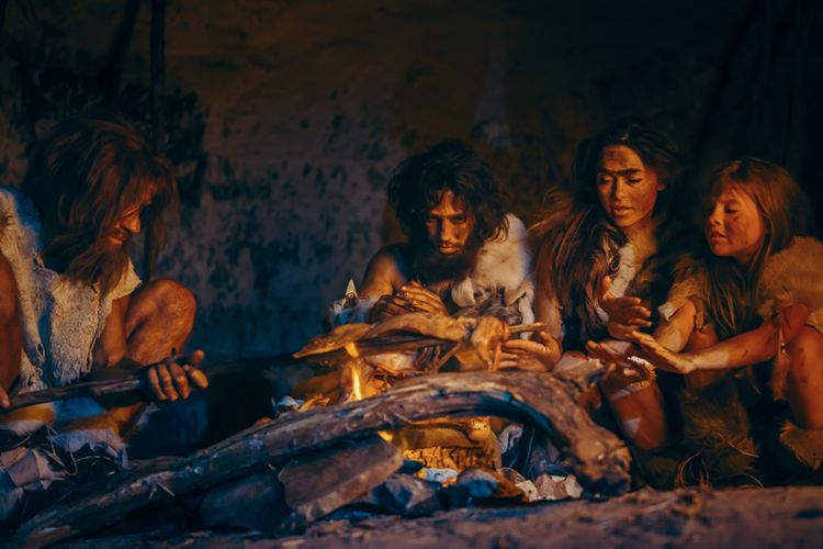 Ilustrasi manusia purba Neanderthal hidup di dalam gua menyalakan api untuk menghangatkan tubuh.