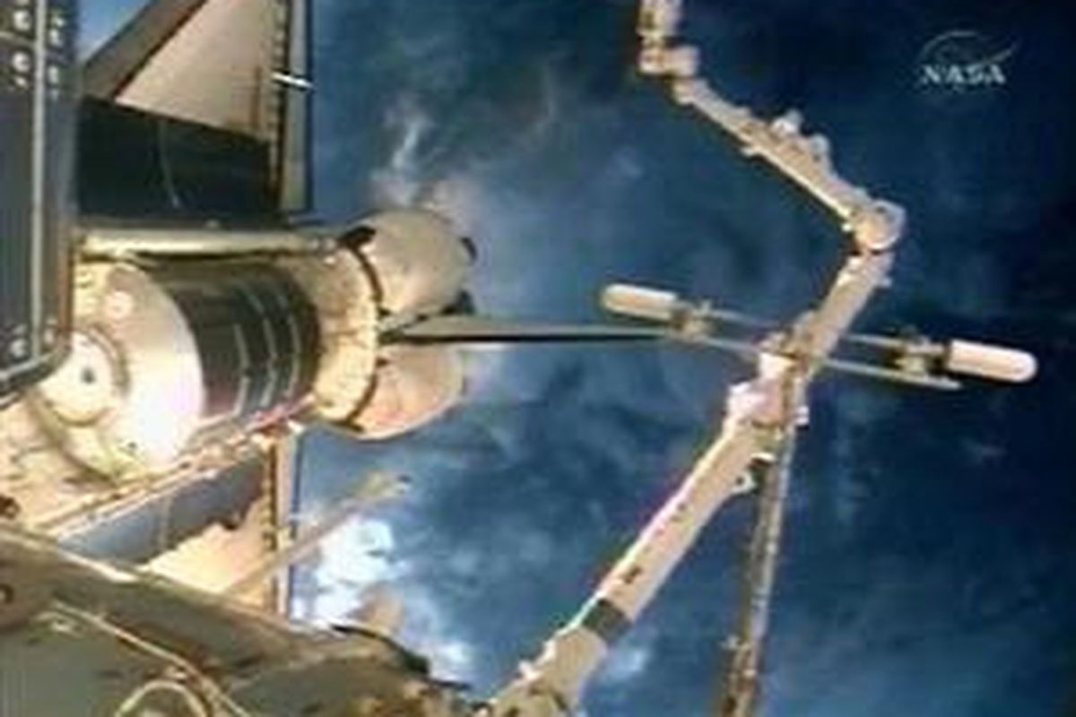 Endeavour terlihat docking dengan Stasiun Ruang Angkasa Internasional dengan latar belakang Bumi saat gambar ini terekam oleh NASA TV 