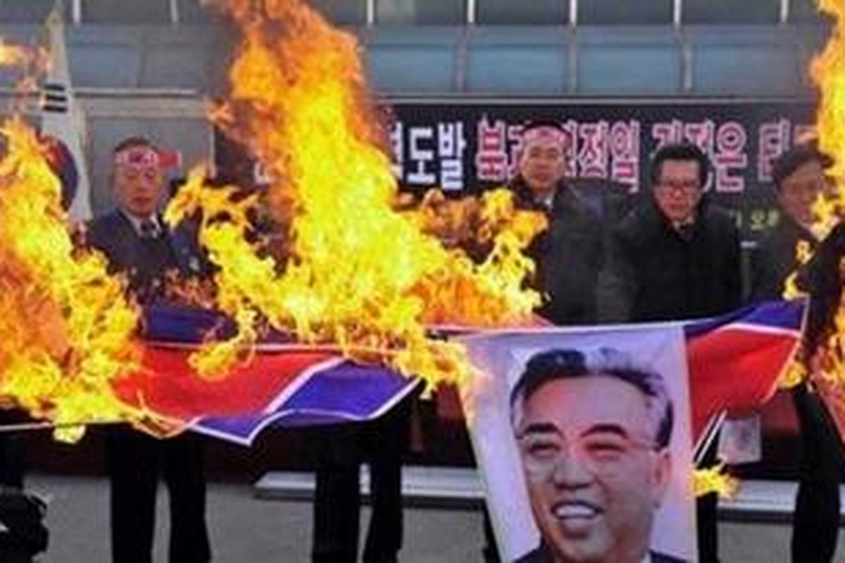 South Korean military veterans burn a North Korean flag and portrait of Kim Il Sung, the late founder of North Korean, during a rally denouncing last weeks North Korean bombardment on a South Korean border island, in Jecheon, South Korea, Friday, Dec. 3, 2010. President Lee Myung-baks choice for new defense minister said Friday that South Korean jets will bomb North Korea if Pyongyang stages an attack similar to last weeks deadly artillery barrage.