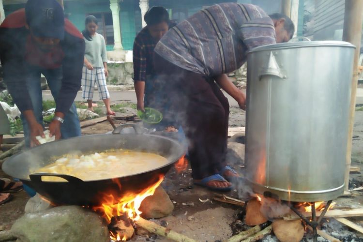Para pria sedang memasak jamuan makan pada sebuah persiapan pesta adat Karo