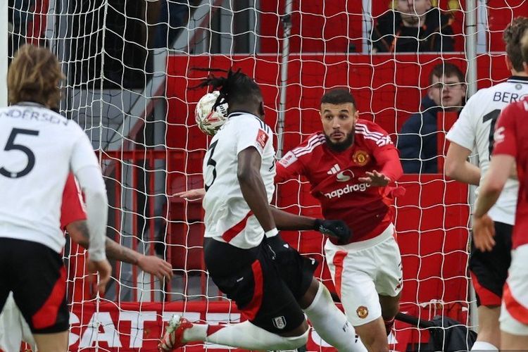 Calvin Bassey kala mencetak gol dalam laga putaran kelima Piala FA 2024-2025 antara Man United vs Fulham di Stadion Old Trafford, 2 Maret 2025. (Photo by Darren Staples / AFP)