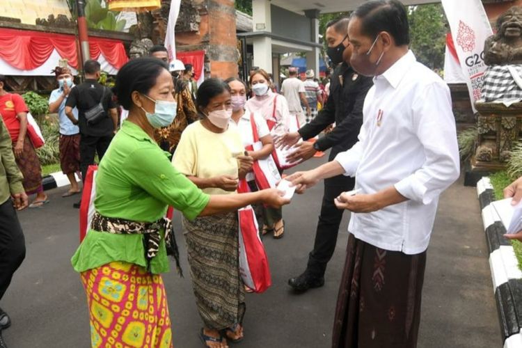Presiden Joko Widodo saat memberikan bansos untuk warga di depan Istana Tampaksiring, Gianyar, Bali, Kamis (5/5/2022).