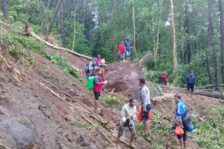 Sejumlah warga di Kabupaten Gowa, Sulawesi Selatan, berusaha menerobos akses jalan yang tertimbun longsor untuk mencari bantuan kebutuhan dasar, meski harus bertarung nyawa,  Jumat, (25/1/2019).