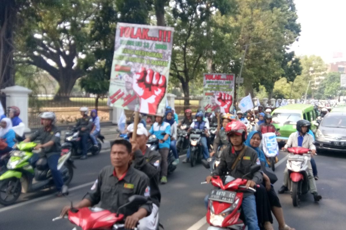 Buruh Kota Bogor saat melakukan konvoi menuju Kantor Balai Kota Bogor untuk melakukan aksi unjuk rasa guna menolak kenaikan iuran BPJS Kesehatan, Senin (2/9/2019).
