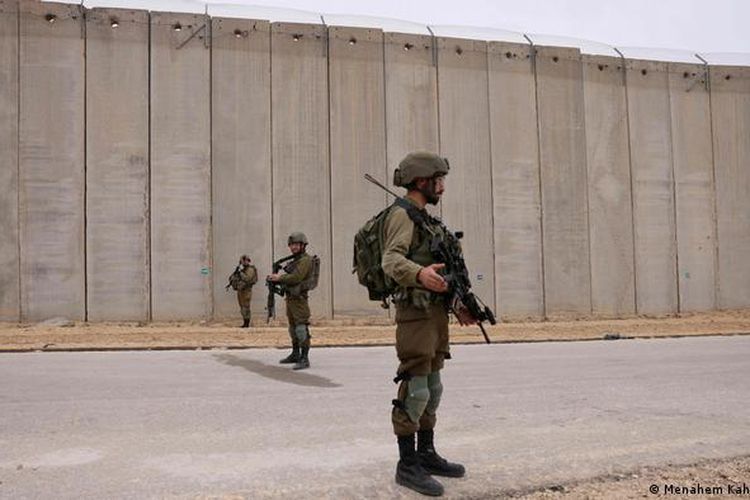 Tentara Israel berjaga di dekat tembok perbatasan Gaza pada akhir tahun 2021.