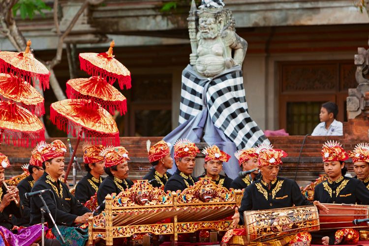 BALI, INDONESIA - June 21, 2015: Musicians of Gamelan orchestra in Balinese people costume playing ethnic ritual music on traditional Indonesian instruments.