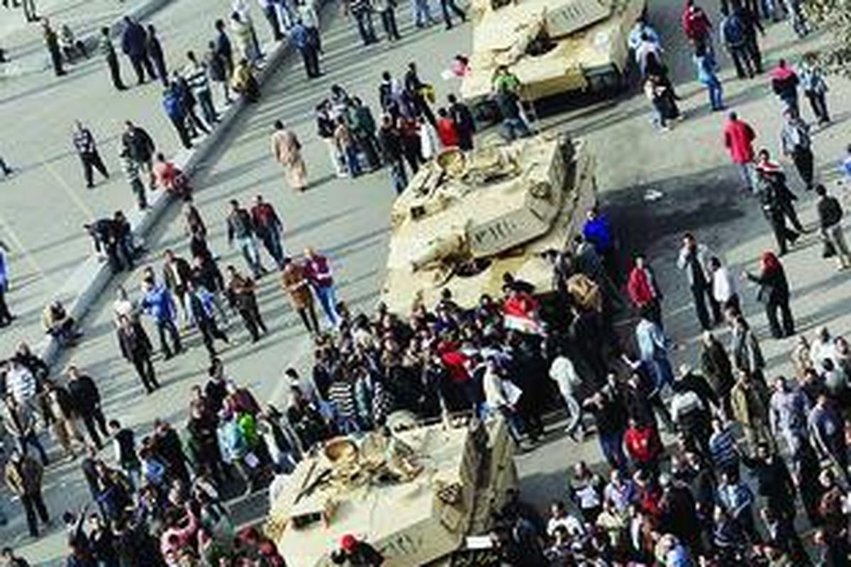 Ribuan pengunjuk rasa berkerumun di dekat tank-tank tentara di Alun-alun Tahrir, Kairo, Mesir, Senin (31/1). Aksi unjuk rasa yang menuntut turunnya Presiden Hosni Mubarak itu telah memasuki hari ketujuh dan melumpuhkan Kairo serta sejumlah kota lainnya.