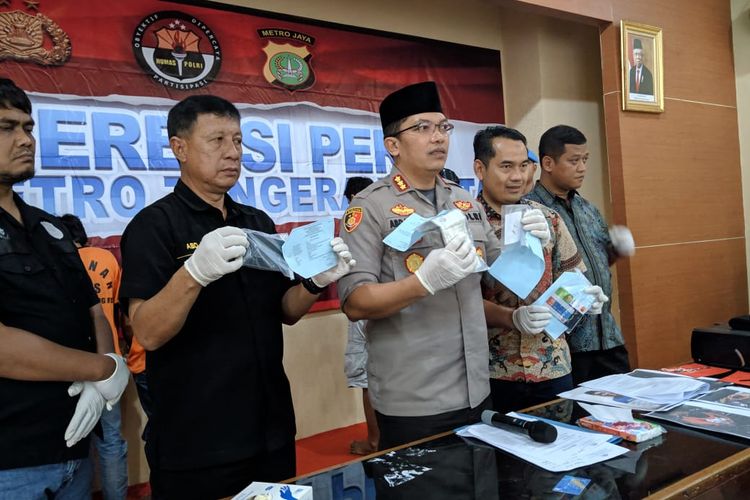 Kapolres Metro Tangerang Kota, Kombes Pol Abdul Rahim (memegang gambar) saat konferensi pers penangkapan pembobolan ATM di Polres Metro Tangerang Kota, Jumat (22/11/2019)