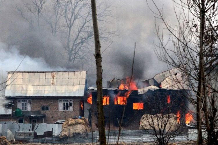 Sebuah rumah diduga tempat militan bersembunyi terbakar usai baku tembak antara pemberontak dan pasukan keamanan India di distrik Pulwama, Kashmir Selatan, Senin (18/2/2019). (AFP)