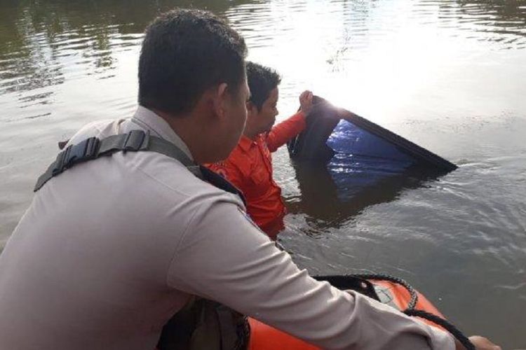 Pihak kepolisian dan warga mengevakuasi mobil Camat Jangkat Timur yang tenggelam di Jalan AMD Muara Bulian, Jambi, Rabu (12/12/2018).