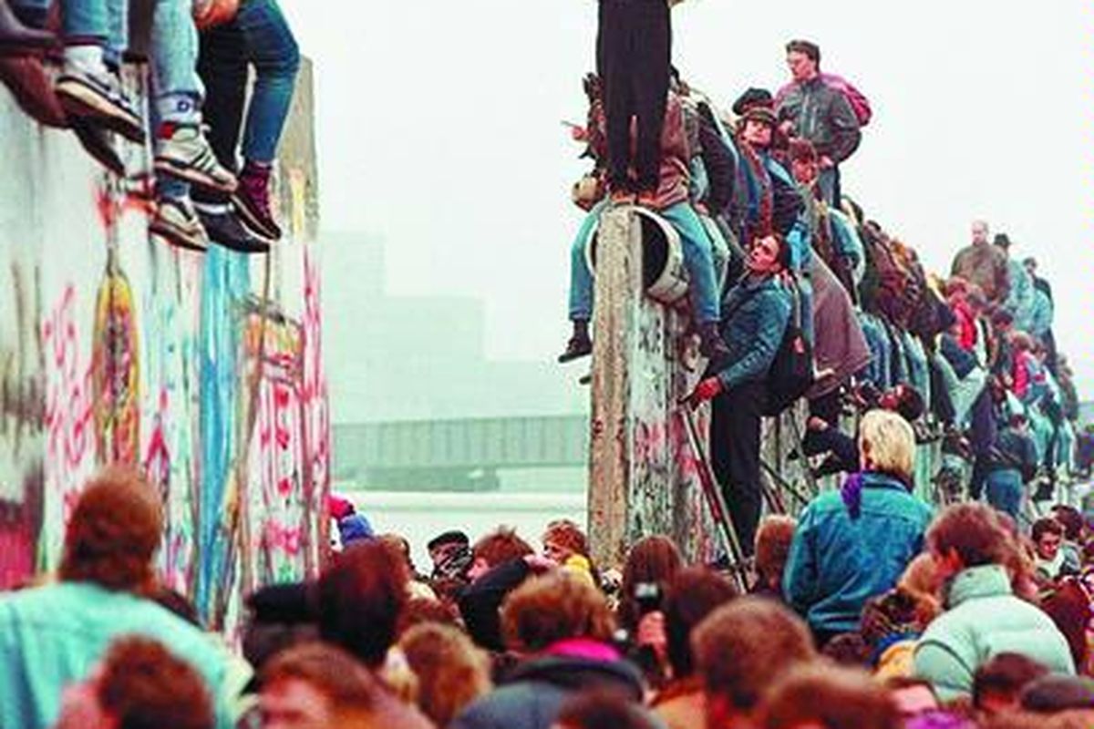 Warga berbagi kebahagiaan saat runtuhnya Tembok Berlin di Jerman, 12 November 1989.