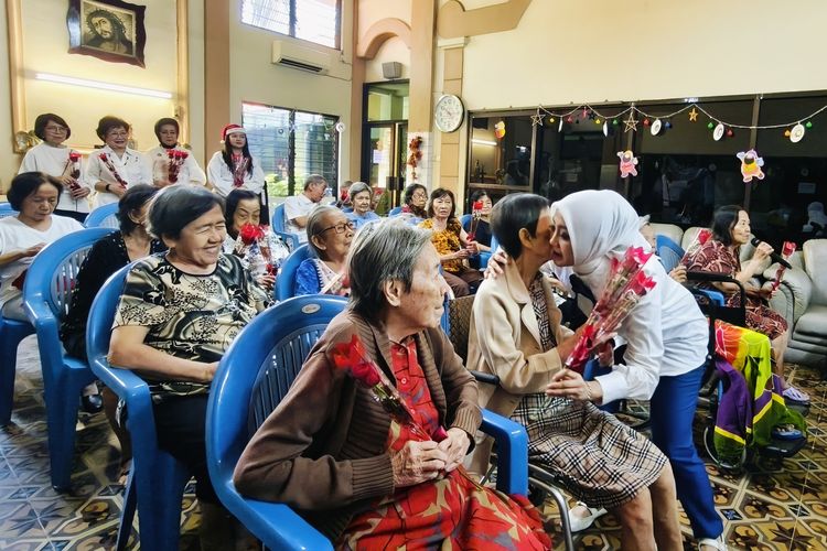 Presiden Rotary Club Surabaya Kaliasin Kika Maryantika memeluk salah satu lansia dalam perayaan Natal bersama dengan suasana hangat di sebuah bangunan tua yang berdiri sejak 1947, Panti Werdha Usia Undaan, Jawa Timur, Rabu (10/12/2015) siang.