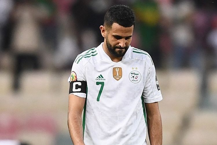 Riyad Mahrez tertunduk setelah Timnas Aljazair, sang juara bertahan Piala Afrika, terdepak dari turnamen seusai menderita kekalahan 1-3 dari Pantai Gading pada laga terakhir fase Grup E, Jumat (21/1/2022).