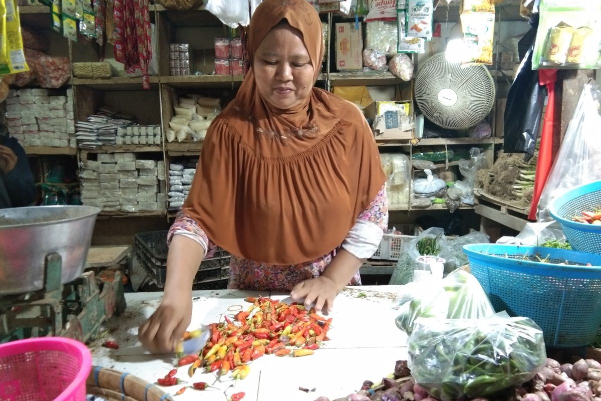 Salah seorang pedagang di Pasar Johar Karawang tengah melayani pembeli, Minggu (19/1/2020). Harga cabai di pasar ini meningkat dua kali lipat.