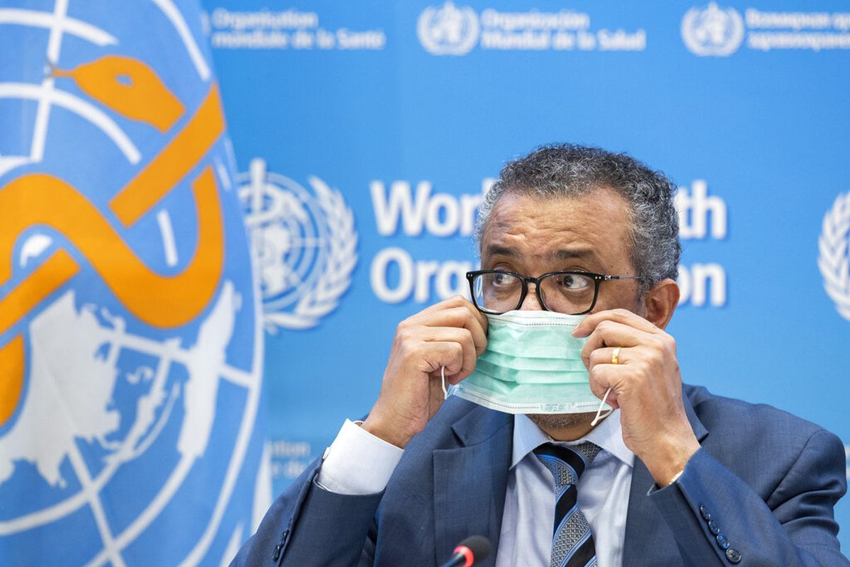 Tedros Adhanom Ghebreyesus, Direktur Jenderal Organisasi Kesehatan Dunia (WHO), melepas masker pelindungnya sebelum berbicara kepada media mengenai virus corona Covid-19 dan prioritas kesehatan global WHO pada 2022, selama konferensi pers baru, di World Health Kantor pusat Organisasi (WHO) di Jenewa, Swiss, Senin, 20 Desember 2021. 