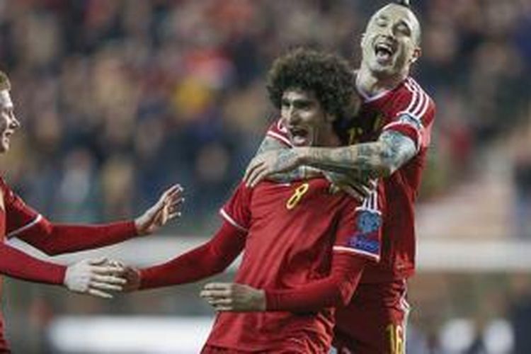 Marouane Fellaini merayakan keberhasilan mencetak gol kala membela Belgia di kualifikasi Piala Eropa 2016. 