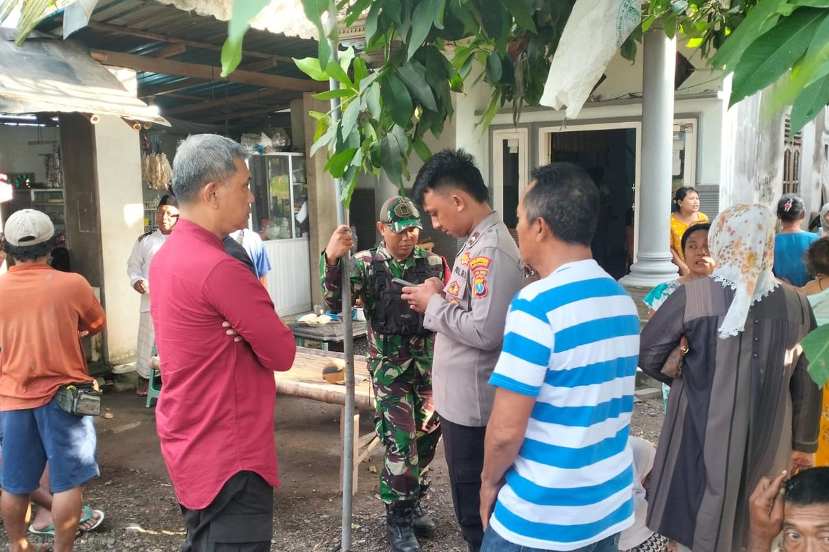 Petugas saat melakukan penyelidikan terhadap bayi yang ditemukan di depan rumah warga di Banyuwangi 