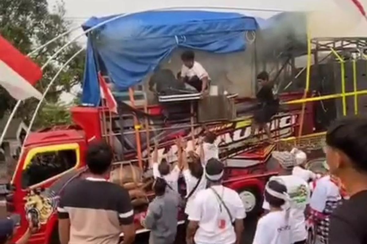 Sound horeg mengasap setelah genset mengalami korsleting akibat percikan air hujan saat karnaval di Kelurahan Ledug, Kecamatan Prigen, Kabupaten Pasuruan Jawa Timur, Selasa (19!08/2025). . Sejumlah penonton pun langsung menjauh karena takut meledak. 