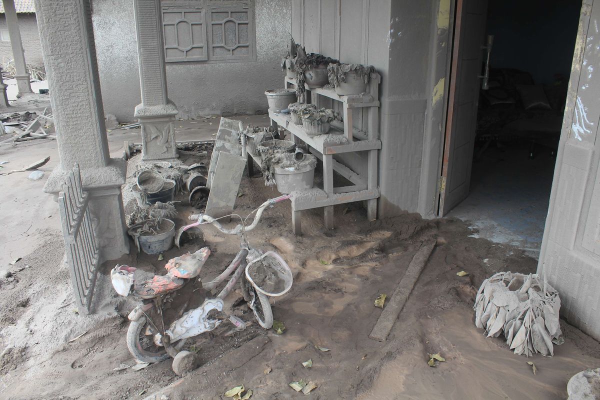 A house covered by volcanic ash after Mount Semeru, one of the most active volcanoes in Indonesia, erupted on Saturday, December 4, 2021. The biggest volcano on Java island erupted for a second time on Monday, December 6, 2021. 