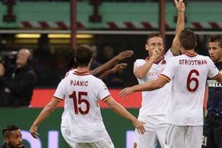 Striker sekaligus kapten AS Roma, Francesco Totti (tengah), bersama rekan-rekannya merayakan gol yang dicetaknya ke gawang Inter Milan dalam laga Serie-A di San Siro, Sabtu (5/10/2013). 