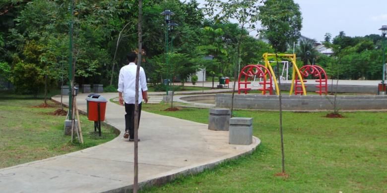 Gubernur DKI Jakarta Joko Widodo berjalan di Taman Mahoni, Ciracas, Jakarta Timur, Rabu (4/12/2013) siang. Dia menginginkan agar ada taman di tengah permukiman penduduk seperti taman tersebut.