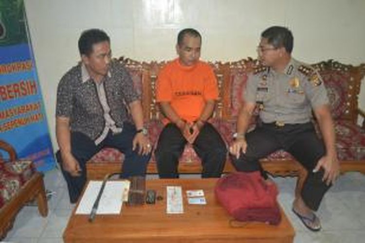 Pelaku (tengah) beserta barang bukti, didampingi Kapolres Singkawang (Kanan) dan Kasat Reskrim (Kiri) ketika memberi keterangan kepada wartawan di markas Polres Singkawang, Kalimantan Barat (8/11/2013)