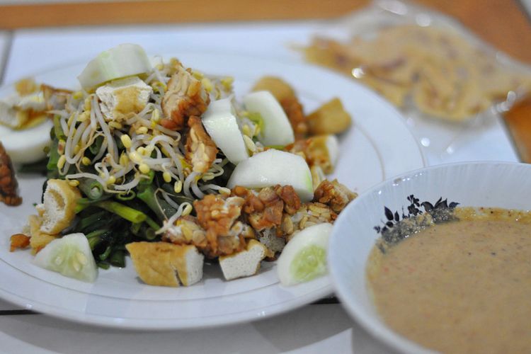  Indonesia?s Gado Gado salad is a beloved traditional dish known for its creamy, savory peanut sauce poured over boiled vegetables.