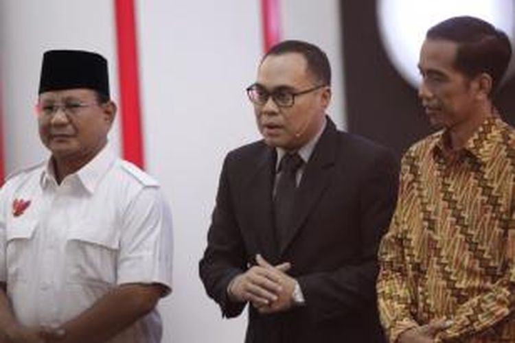 Calon presiden nomor urut 1 Prabowo Subianto dan nomor urut 2 Joko Widodo didampingi moderator Hikmahanto Juwana (tengah) usai debat capres putaran ketiga, di Hotel Holiday Inn, Kemayoran, Jakarta, Minggu (22/6/2014). Debat capres kali ini mengangkat tema 'Politik Internasional dan Ketahanan Nasional'.