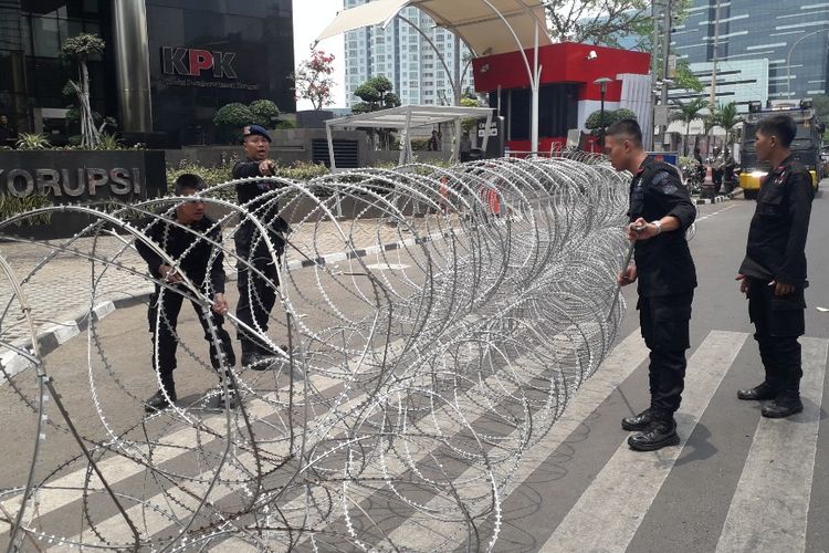 Aparat kepolisian memasang barikade kawat berduri di depan Gedung Merah Putih KPK, Senin (23/9/2019).