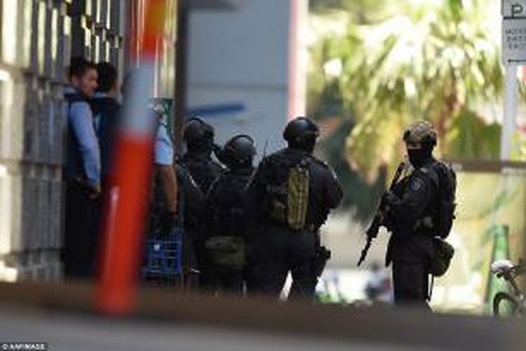 Polisi bersenjata berat berada di semua sudut Martin Place, kawasan pusat keuangan di Sydney, Australia, Senin (15/12/2014), dalam sebuah respons terhadap penyanderaan sejumlah orang di sebuah kafe di daerah itu oleh seorang pria bersenjata.