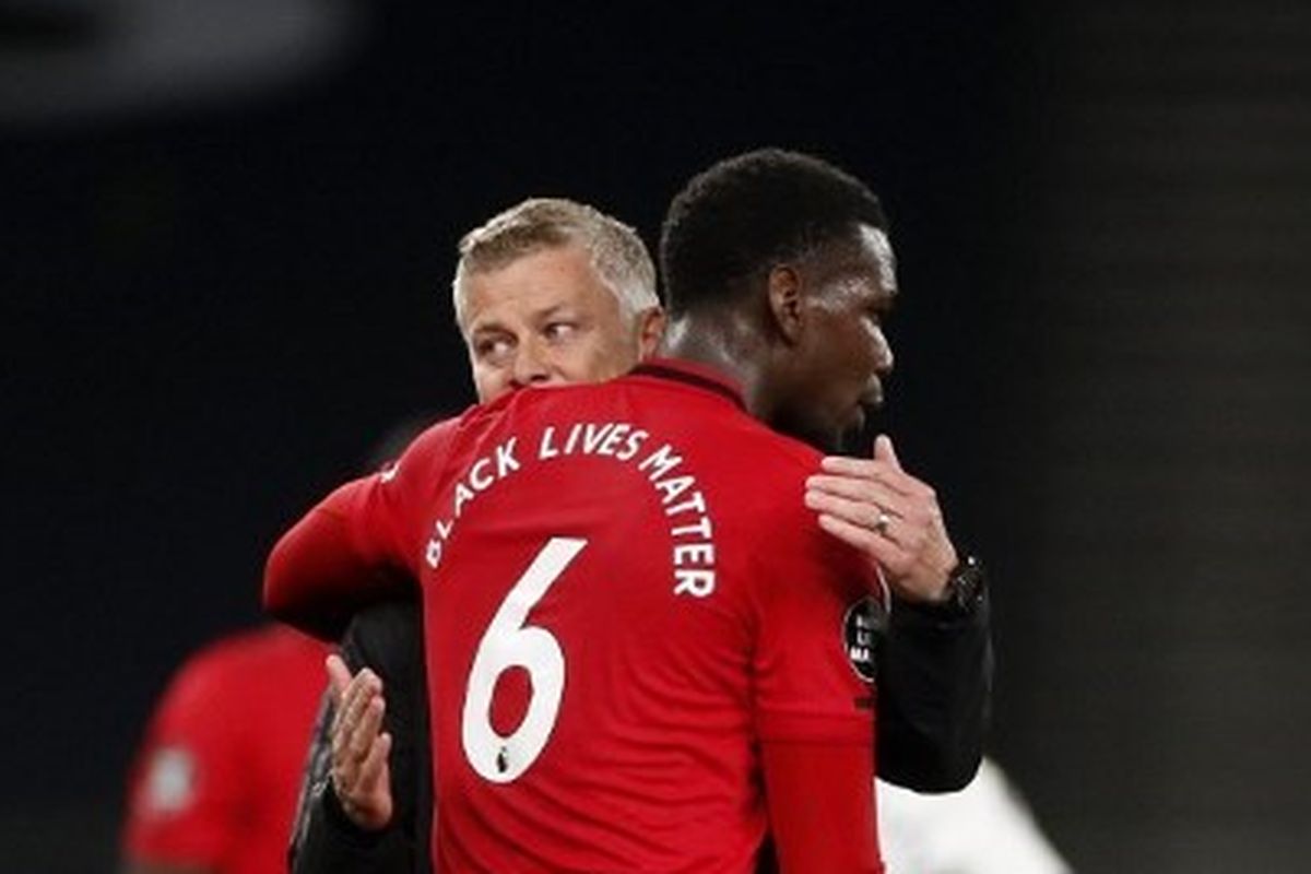 Paul Pogba berpelukan dengan Ole Gunnar Solskjaer usai laga Tottenham Hotspur vs Manchester United pada lanjutan pekan ke-30 Liga Inggris di Tottenham Hotspur Stadium, Sabtu (20/6/2020). 