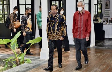 Presiden Joko Widodo (kedua kanan) berjalan bersama Perdana Menteri Singapura Lee Hsien Loong (kanan) di The Sanchaya Resort Bintan, Kabupaten Bintan, Kepulauan Riau, Selasa (25/1/2022). Pertemuan tersebut membahas upaya penguatan kerja sama bilateral yang mana pada tahun ini merupakan tahun peringatan 55 tahun hubungan diplomatik Indonesia-Singapura.