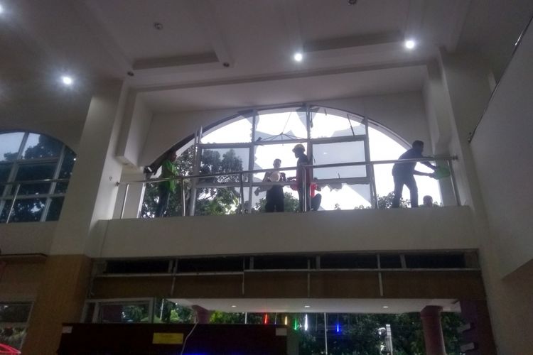 Sejumlah pekerja sedang merapikan kaca Rumah Sakit Mulia Kota Bogor yang ambruk akibat angin kencang, Rabu (21/11/2018).