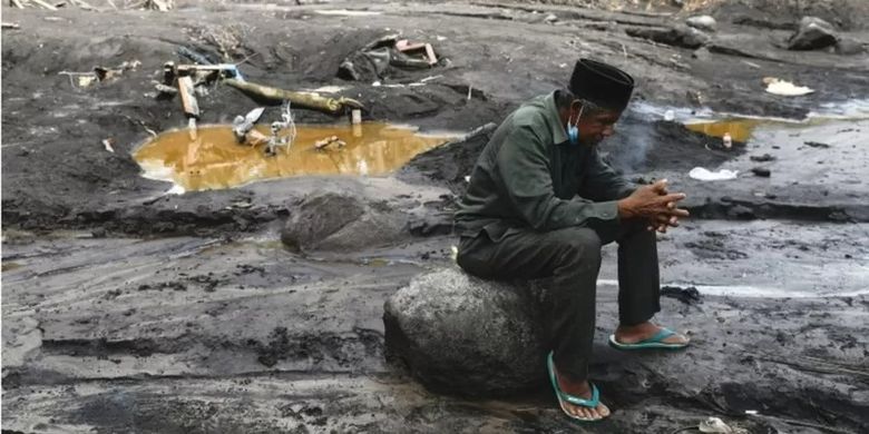 Musmin, 55, mengunjungi sebuah lokasi yang dia yakini sebagai tempat cucunya terkubur materi vulkanis Gunung Semeru.