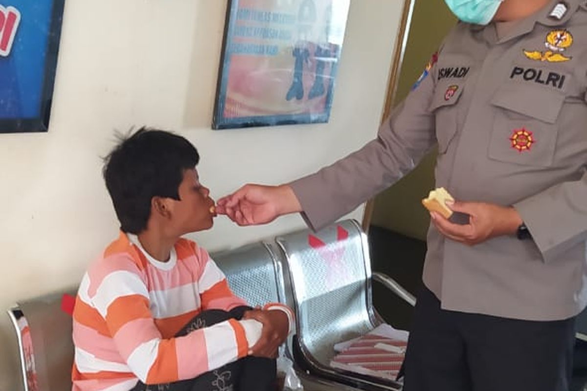 Bhabinkamtibmas Bandungan Bripka Iswandi menyuapi perempuan yang tersesat di pasar