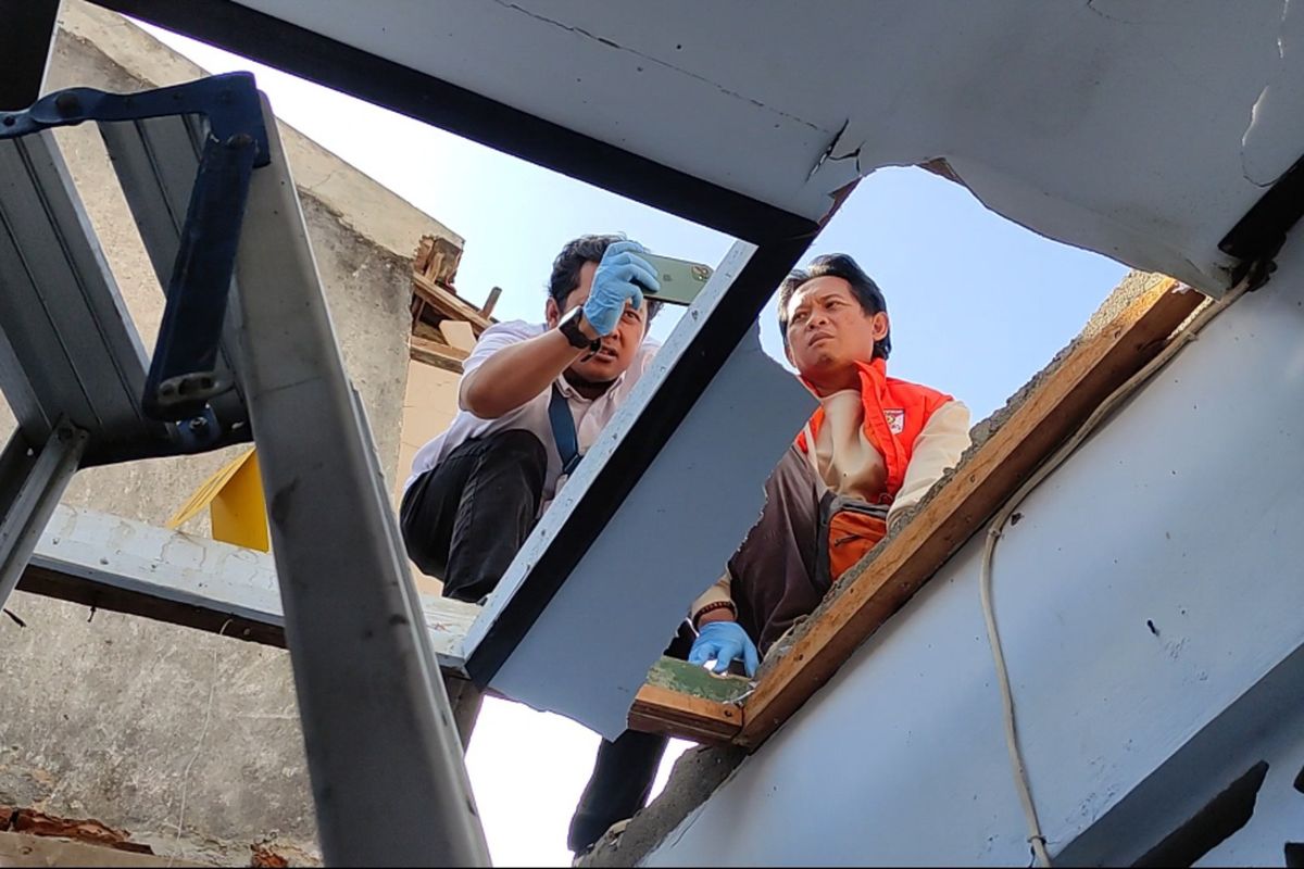 Tim Inafis satreskrim Polres Trenggalek.lalukan olah TKP di lokasi balon udara ber petasan yang jatuh timpa rumah warga kelurahan Surodakan Trenggalek, Jawa Timur, Senin (7/4/2024).