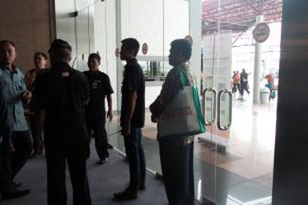 Paspampres yang mengawal presiden terpilih Joko Widodo tengah berbincang dengan petugas keamanan JIExpo Kemayoran, Jakarta. Pintu itu ingin digunakan sebagai pintu keluar, namun terkunci.

