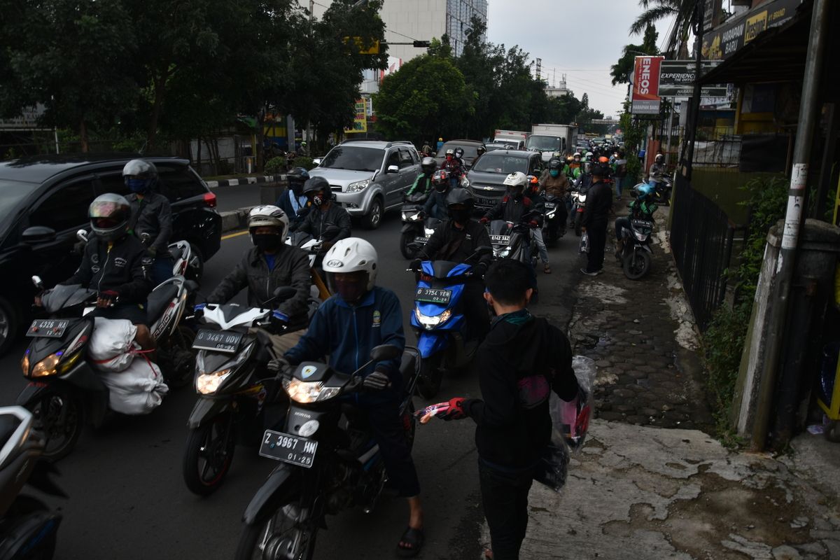 Sejumlah warga menjajakan dagangannya berupa masker dan sarung tangan di pinggir jalan sebelum pemeriksaan petugas di Check Point saat PSBB Jabar diberlakukan, Rabu (6/5/2020).