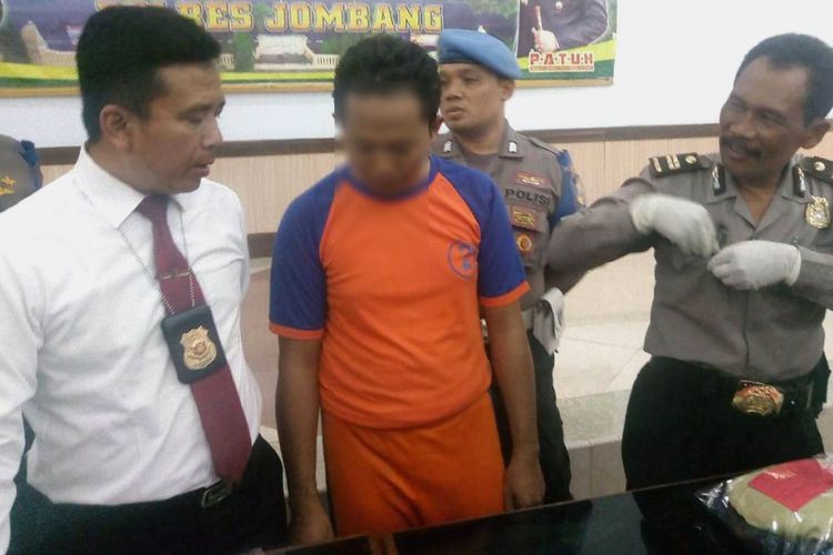 KHS (36), Guru SDN terduga pelaku kasus pencabulan terhadap 2 anak SD, didampingi Kasat Reskrim Polres Jombang, AKP Gatot Setyo Budi (kiri) dan Kasubbag Humas Polres Jombang, Iptu Sarwiaji (Kanan).