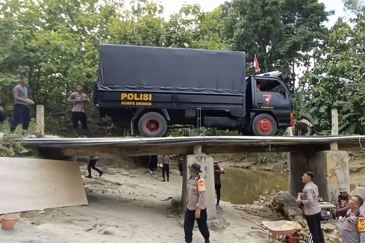Polisi melakukan perbaikan pembatas jembatan di Bangkalan, Jawa Timur.