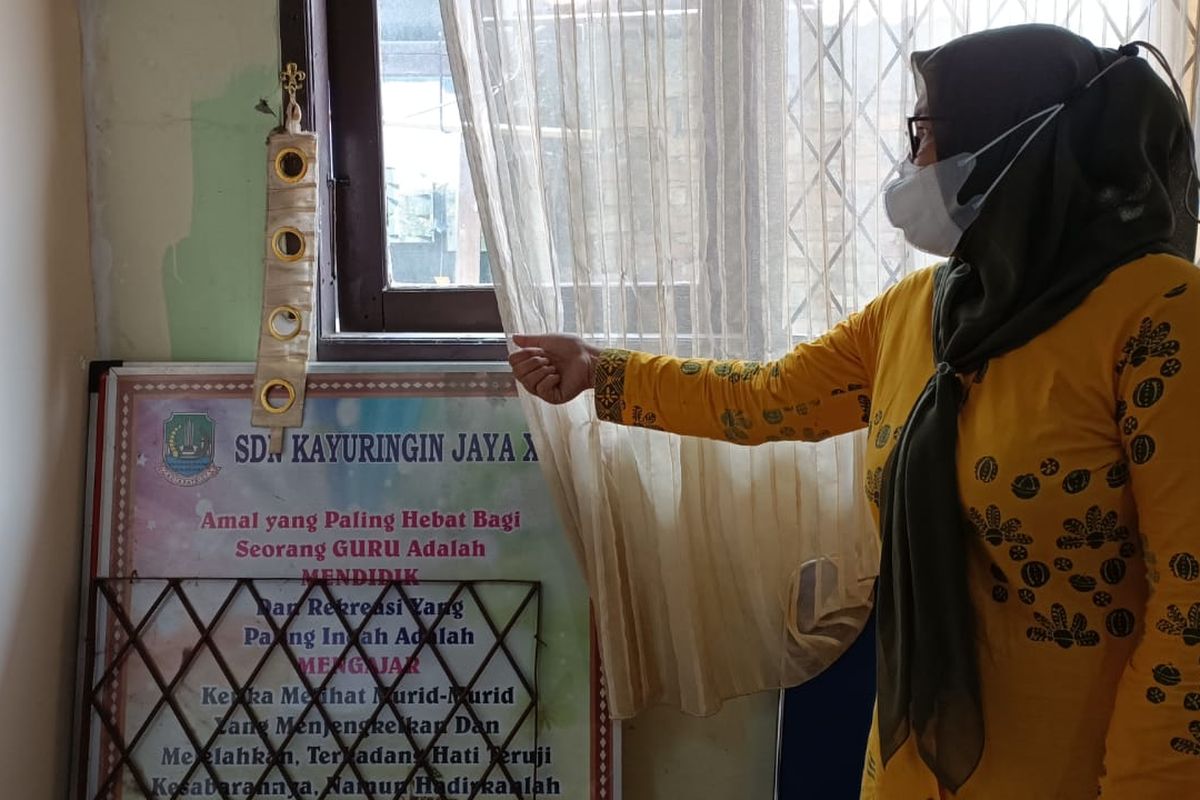 Kepala Sekolah SD Negeri Kayuringin Jaya XIX Ramadhani Susanti saat menunjukkan jendela ruangan guru yang dibobol oleh maling. Dari aksi tersebut, 10 barang elektronik ikut dibawa kabur dan pihak sekolah mengalami kerugian hingga Rp 80 juta. 