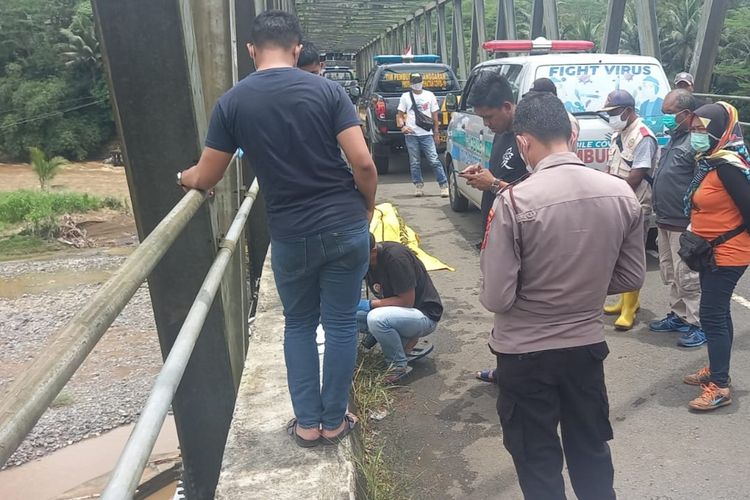 Warga petugas Kepolisian, TNI dan BPBD Kabupaten Tasikmalaya, Jawa Barat, sedang mengevakuasi sosok mayat tangan terborgol yang mengambang di bawah Jembatan Sungai Ciwulan, Kampung Sukarame Kecamatan Karangnunggal, Kabupaten Tasikmalaya, Minggu (6/11/2022).