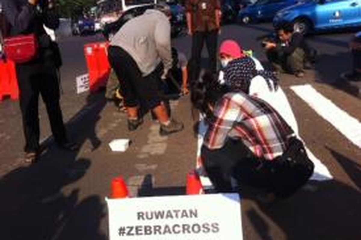 Koalisi Pejalan Kaki melakukan pengecatan ulang zebra cross di Jalan Kebon Kacang Raya, Jumat (19/9/2014).
