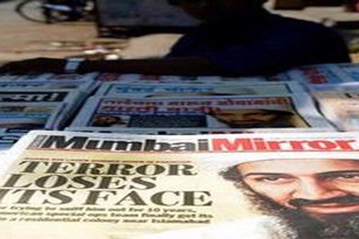 An Indian vendor sits besides newpapers displaying headlines portraying the killing of Osama Bin Laden at a roadside stall in Mumbai on May 3, 2011. US Navy SEALs led the commando operation in Pakistan early May 2, 2011, that ended the life of 9/11 mastermind Osama bin Laden with a bullet to the head, a US official told AFP.
