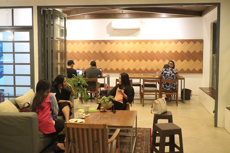 Pengunjung tengah duduk sambil berbincang dengan rekannya di kedai Dua Coffee, Jakarta, Selasa (23/5/2017). Dua Coffee menyediakan makanan mulai dari pembuka hingga penutup serta minuman ringan seperti kopi, latte, dan cappucino.