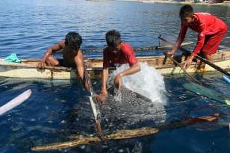 Anak-anak nelayan bercanda dengan hiu paus di pantai Botubarani Kecamatan Kabila Bone Kabupaten Bone Bolango, Gorontalo