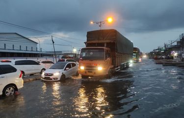 Sejumlah kendaraan melintas di Pantura Kecamatan Sayung, Kabupaten Demak, Jawa Tengah dalam kondisi banjir rob, Minggu (6/4/2025) malam.