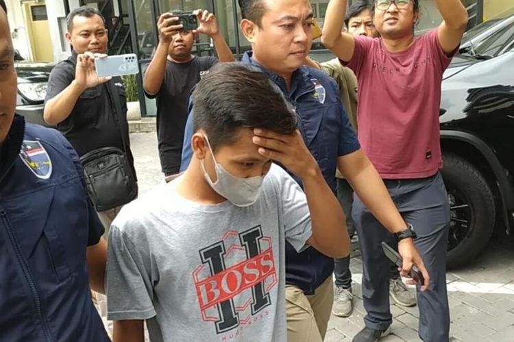 AWK (tengah), pengguna Tiktok pengancam Anies Baswedan ditahan di Mapolda Jatim.